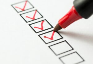 red-tip-felt-pen-checking-off-boxes-on-checklist